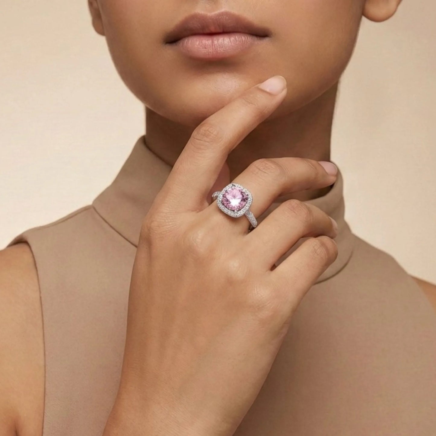 Woman wearing Pink Cushion Halo Ring against a beige background